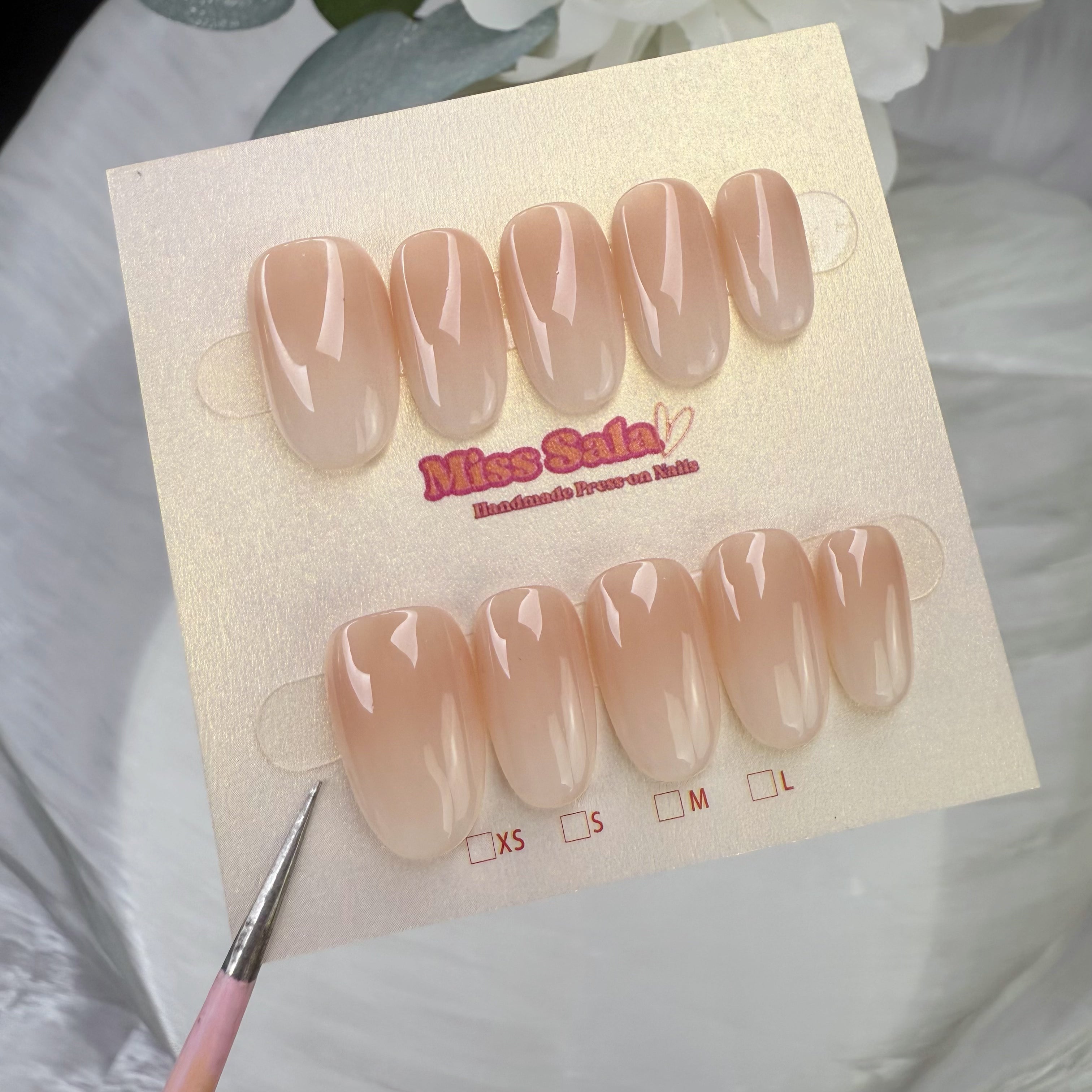 Short round-shaped press-on nails with a glossy nude-to-white ombre gradient finish, featuring a seamless transition from a soft tan base to milky white tips.