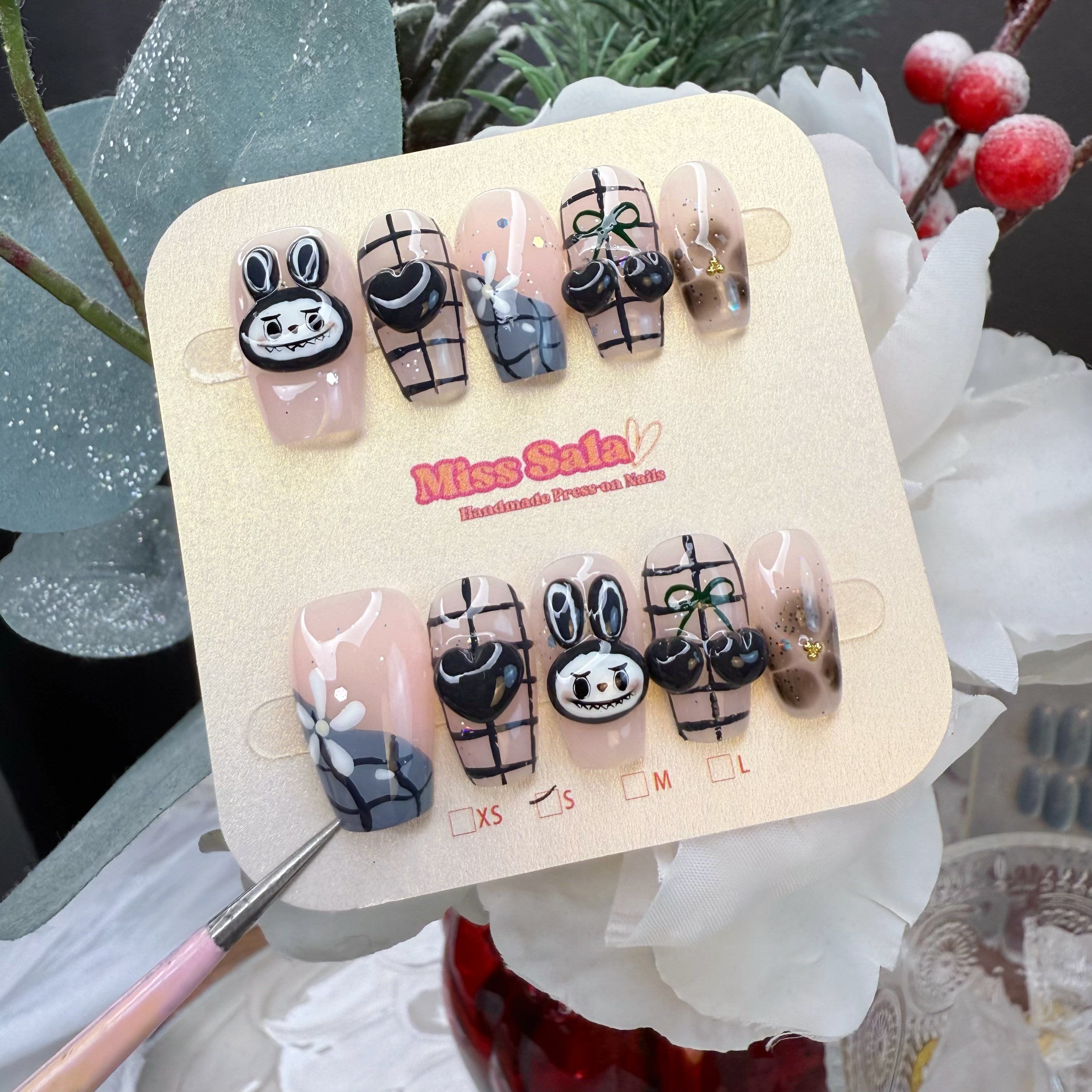 Nude and Grey Press-On Nails with 3D Black Bubu Bunny, Glossy 3D Cherries, Black Plaid Patterns, and Heart Charms in a Y2K Goth Aesthetic