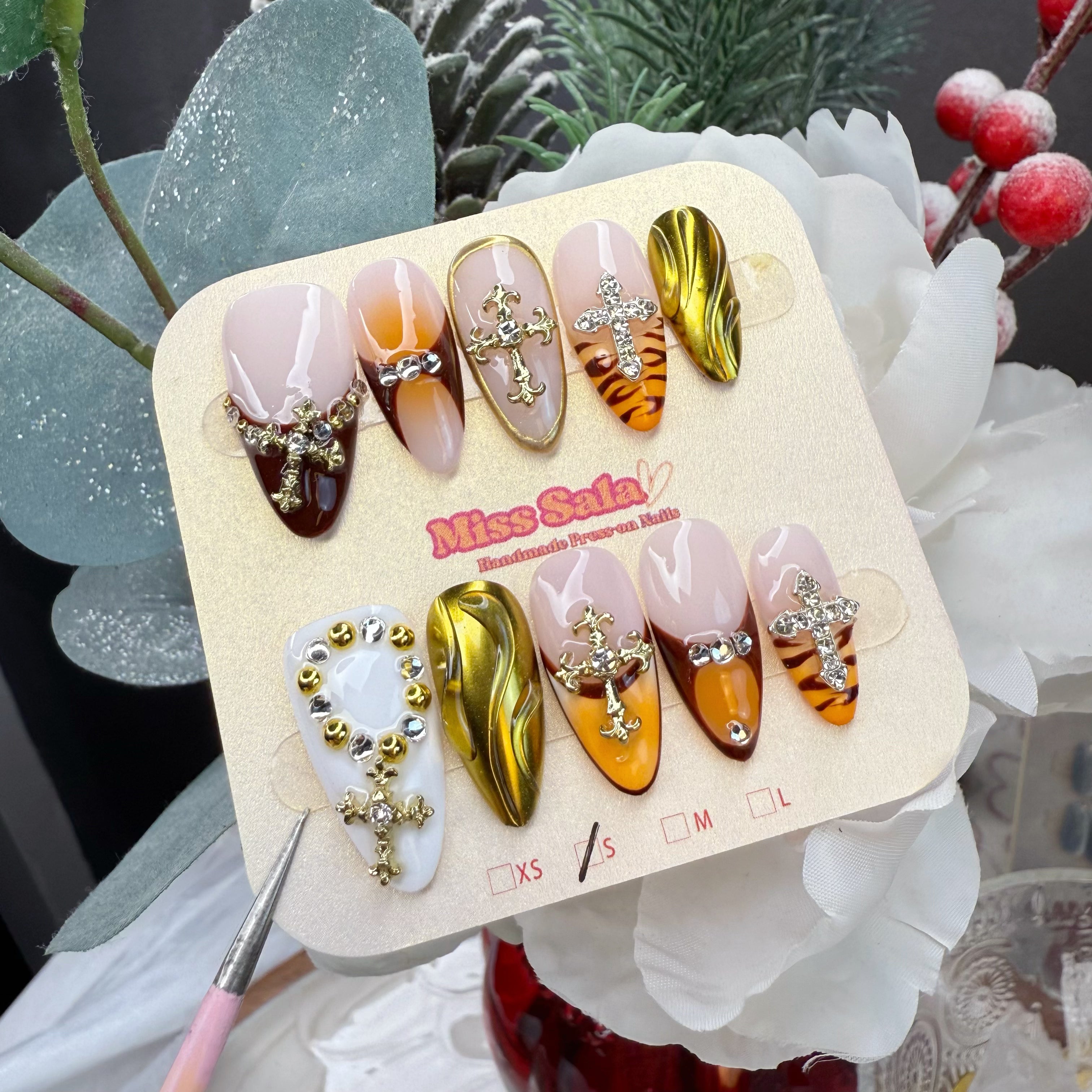 Almond-Shaped Press-On Nails with Amber Aura Gradients, 3D Gold Liquid Chrome Swirls, and Large Ornate Gold and Silver Cross Charms