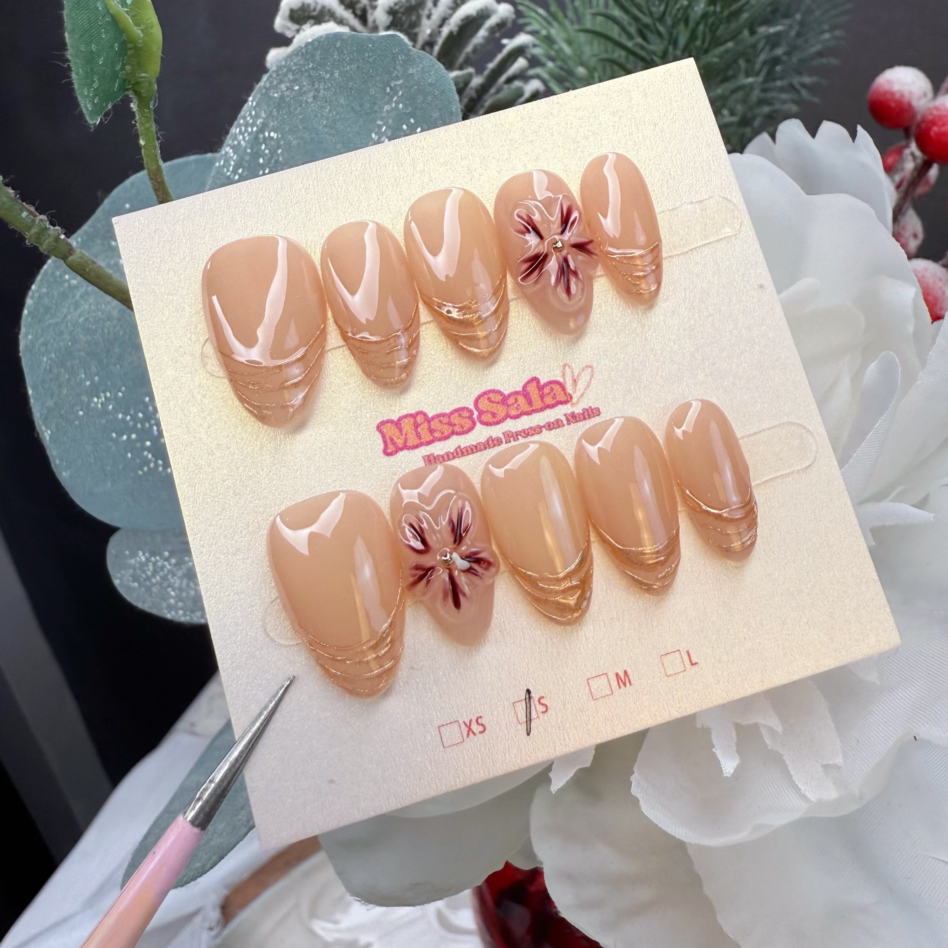 Almond-Shaped Press-On Nails with a Nude Base, Triple Layered Rose Gold Metallic French Tips, and Hand-Painted Daisy Accents