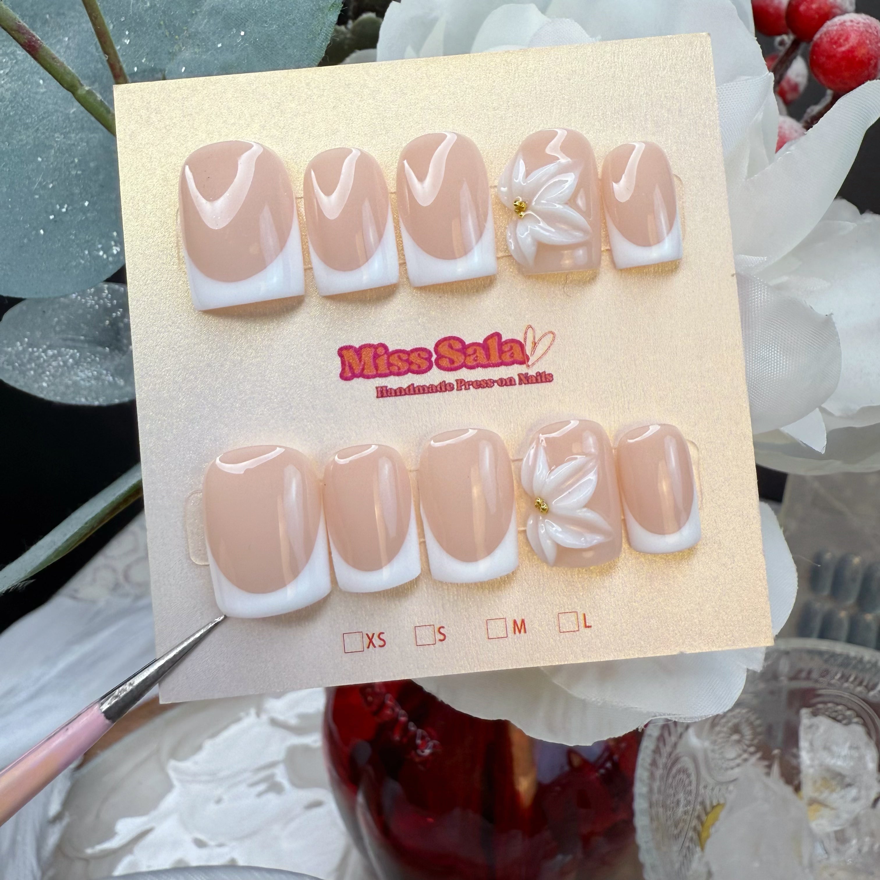 Classic Nude French Tip Press-On Nails in a Short Square Shape featuring 3D Hand-Sculpted White Flower Art with a Gold Center Detail