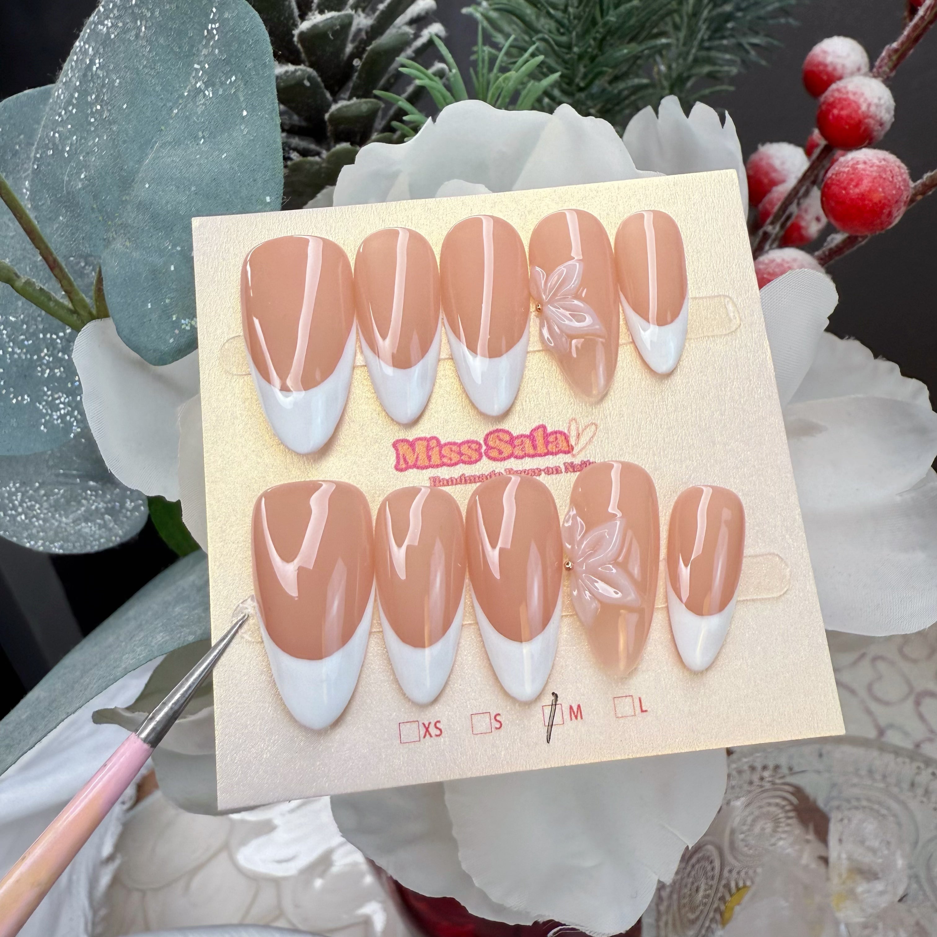 Almond-Shaped Press-On Nails with a Nude Base, Classic White French Tips, and a Large Translucent 3D Sculpted Flower Accent with a Gold Center Stud