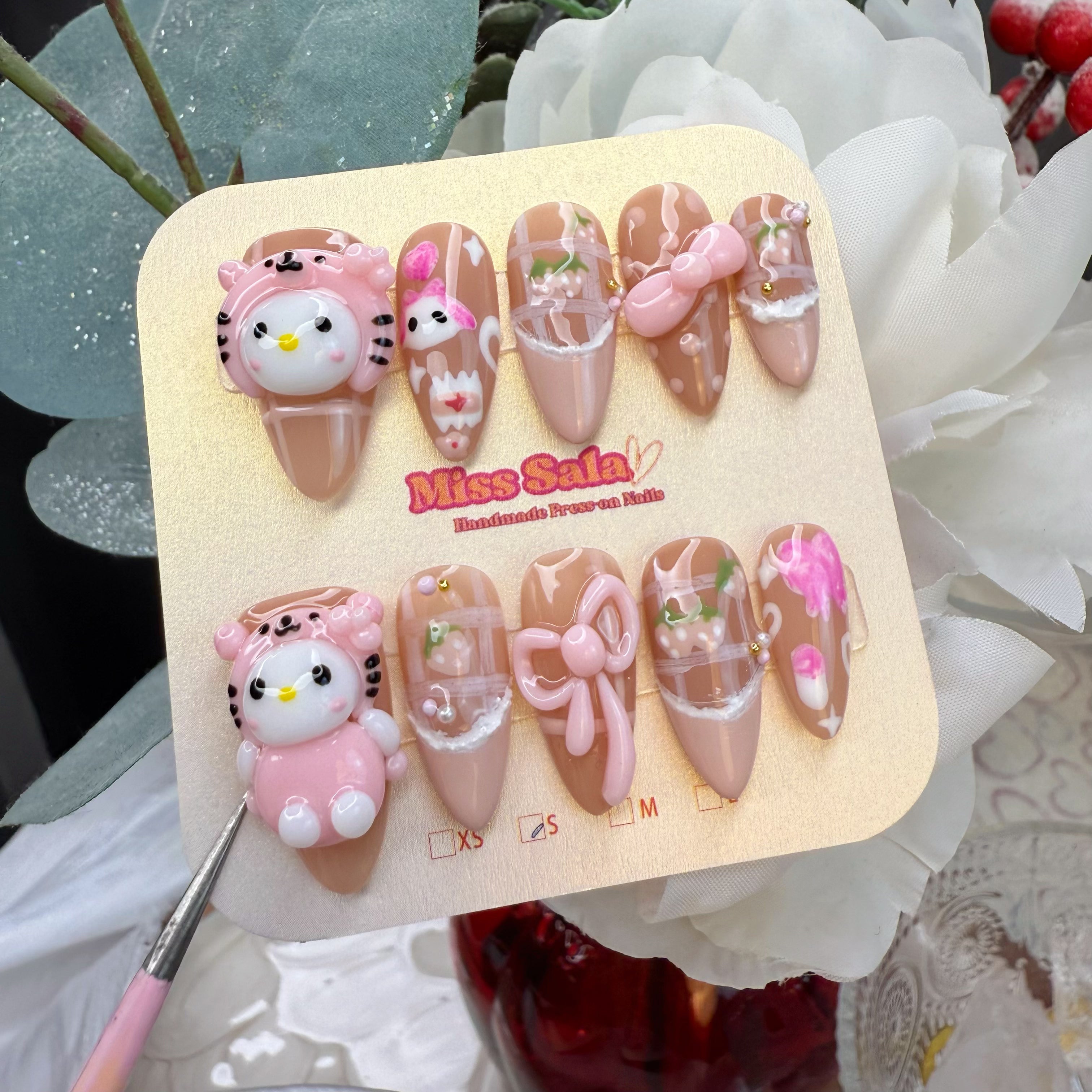 Almond-Shaped Press-On Nails featuring 3D White Kittens in Pink Tiger Hoods, Large Pink 3D Bows, Gingham Patterns, and Hand-Painted Strawberry Details