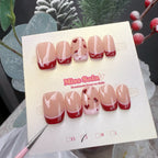 Short square press-on nails with a glossy nude base, featuring red and soft pink double-layered French tips, hand-painted red hearts, and pink polka dot accents.